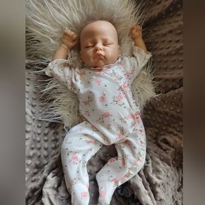 Realistic vinyl baby doll.